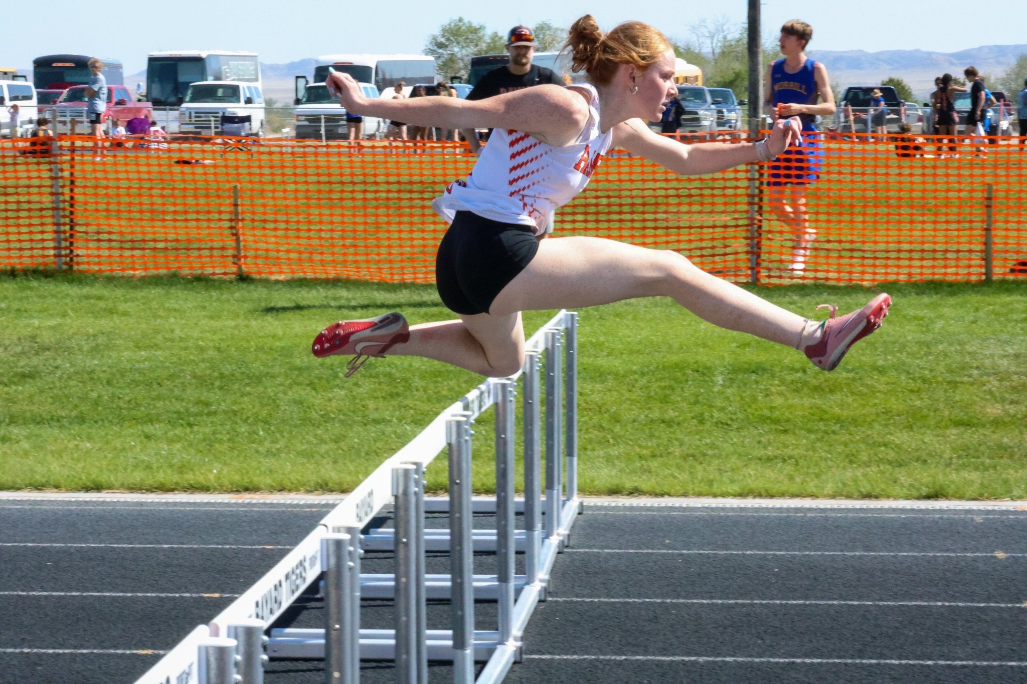 Track athlete clearing hurdles